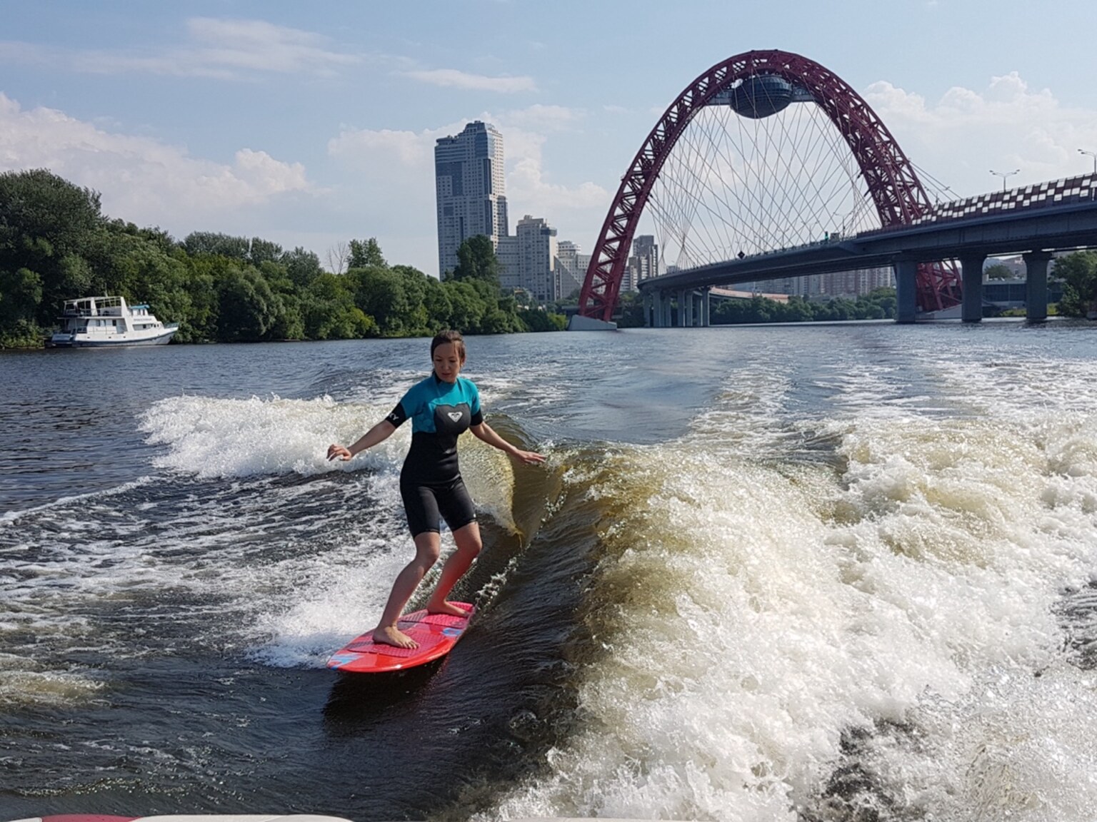 Katerina Valkova wake surfing on a river